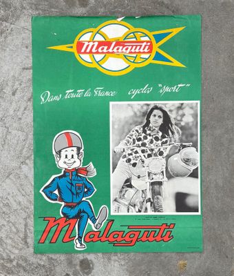 a sign on the side of a building with a picture of a man on a motorbike
