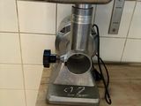 a meat grinder sitting on a counter in a kitchen