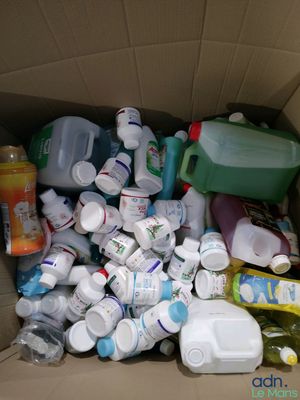 a cardboard box filled with many different types of bottles