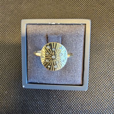 une bague en or et en argent ornée d'un motif en forme d'étoile rayonnante