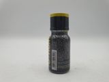 a close up of a bottle of black paint on a white surface