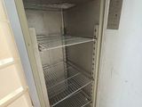 an empty refrigerator with a door open in a kitchen