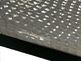 a close up of a metal plate on a table