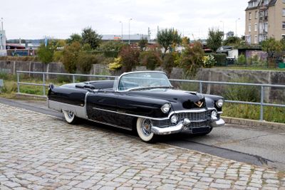 a black and white car parked on the side of the road