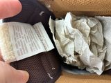 a person that is holding a piece of paper in their hand