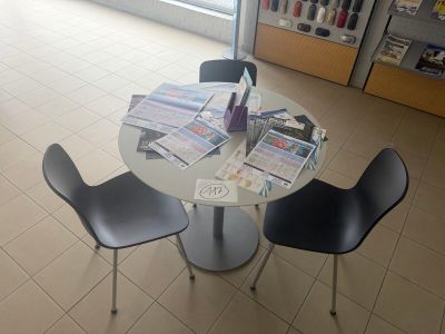 a table with two chairs and a table with magazines on it