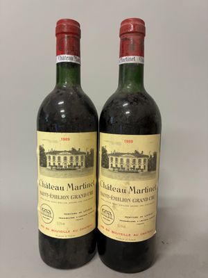 two bottles of wine sitting on top of a table next to each other