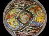 a glass bowl with a design on it on a black background