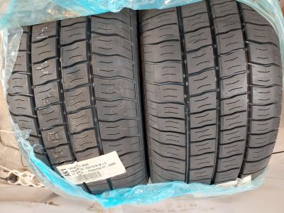 two tires are wrapped in plastic on a white surface