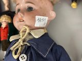 a close up of a doll with a tag on it ' s head