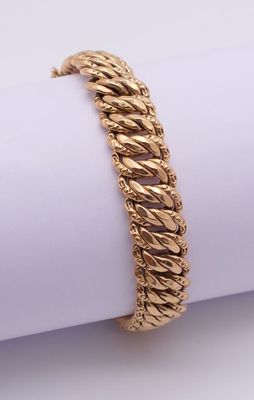 a gold bracelet on top of a napkin