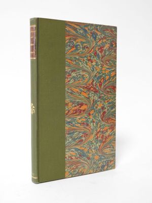 a book with a green cover sitting on top of a white surface
