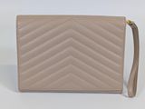 a beige leather wallet with a chevron pattern on the front