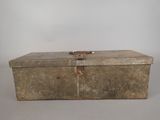 an old metal box sitting on top of a white table