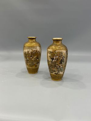 pair of antique chinese vases on display on a white surface