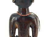 an image of a wooden statue of a man with a bird on his shoulder