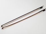 a pair of wooden and metal walking canes on a white surface