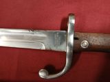 a close up of a knife on a red cloth