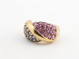 un gros plan d'une bague en or sertie de pierres violettes