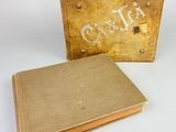 an old book sitting next to a box with the word caulia written on it
