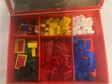 a red box filled with legos and other toys