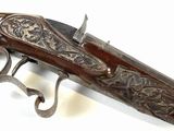 a close up of a gun on a white surface with a white background