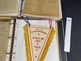 three open books with pennants on them sitting on top of a table
