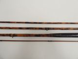 three different types of fishing rods on a white surface
