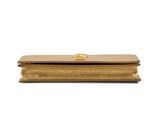 a gold clutch bag on a white background