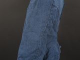 a blue jean jacket on a mannequin stand against a black background