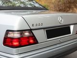 a silver car that is parked on the side of the road