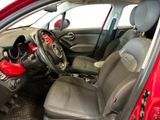 the interior of a red car with a steering wheel and dashboard