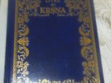 un livre bleu avec des inscriptions dorées, posé sur un lit