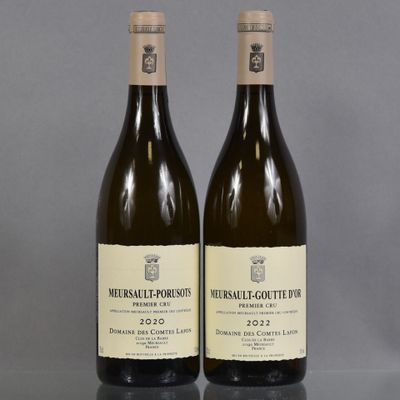two bottles of wine sitting on top of a table next to each other
