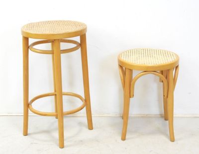 two wooden stools sitting next to each other against a white wall