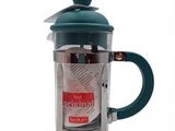 La cafetière à piston est en acier inoxydable et possède un couvercle vert.