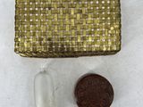 an image of a small gold purse next to a penny