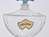 an image of a small glass bottle with a blue label on it
