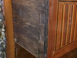 a wooden cabinet with a drawer on top of it