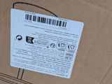 a cardboard box with a sticker on it that has a barcode on it