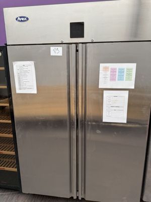 a stainless steel refrigerator with a glass door next to a wine cooler