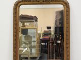 a mirror that is sitting on the floor in front of a wall