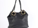 a black handbag with gold handles on a white background