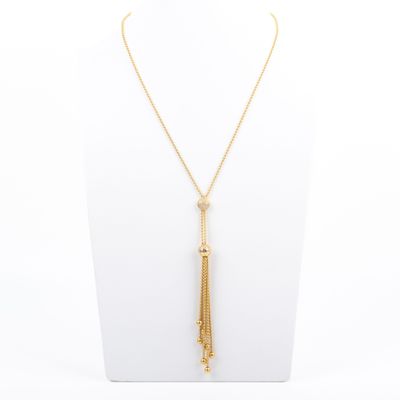 a gold necklace with a tassel on a mannequin neck