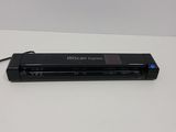 an image of a black scanner sitting on top of a white table