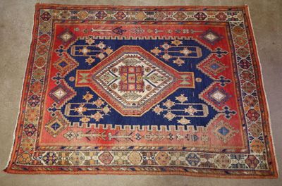 an old rug with a blue and red design on it