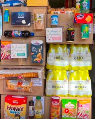 boxes of food and drinks are stacked on top of each other in a store