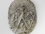 an image of a silver medallion with a woman holding a sword