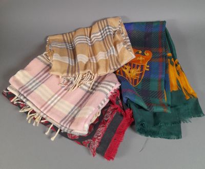 several scarves are stacked on top of each other on a table