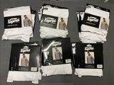 six pairs of men ' s white socks are on a table